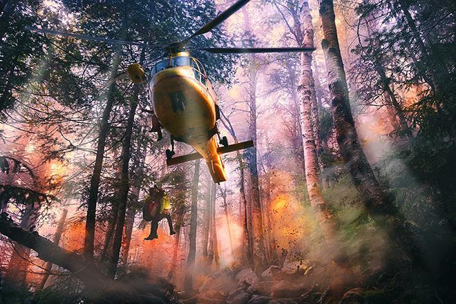 fire helicopters flying over a burning forest